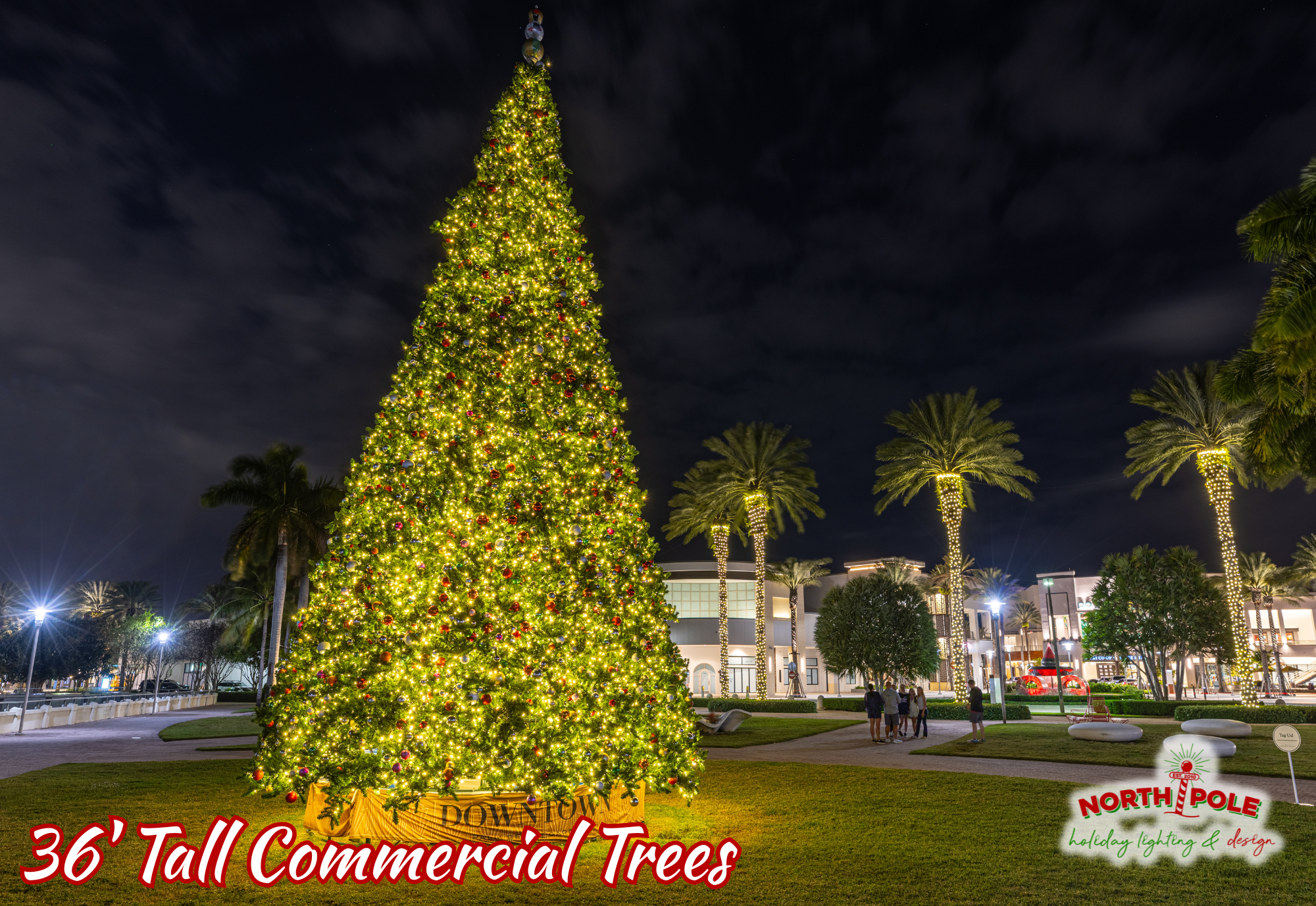 Massive 36-foot tall decorated commercial Christmas tree at a retail center in Palm Beach Gardens.