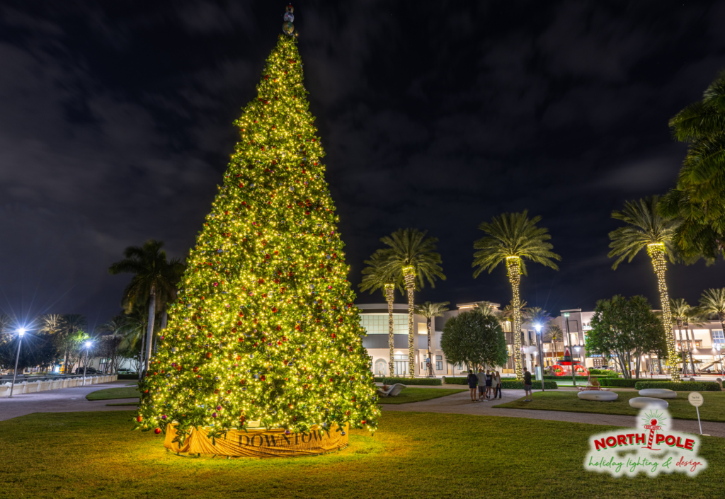 Downtown at the Gardens holiday tree lighting with lit palm trees and warm white commercial LEDs, Palm Beach Gardens, FL.