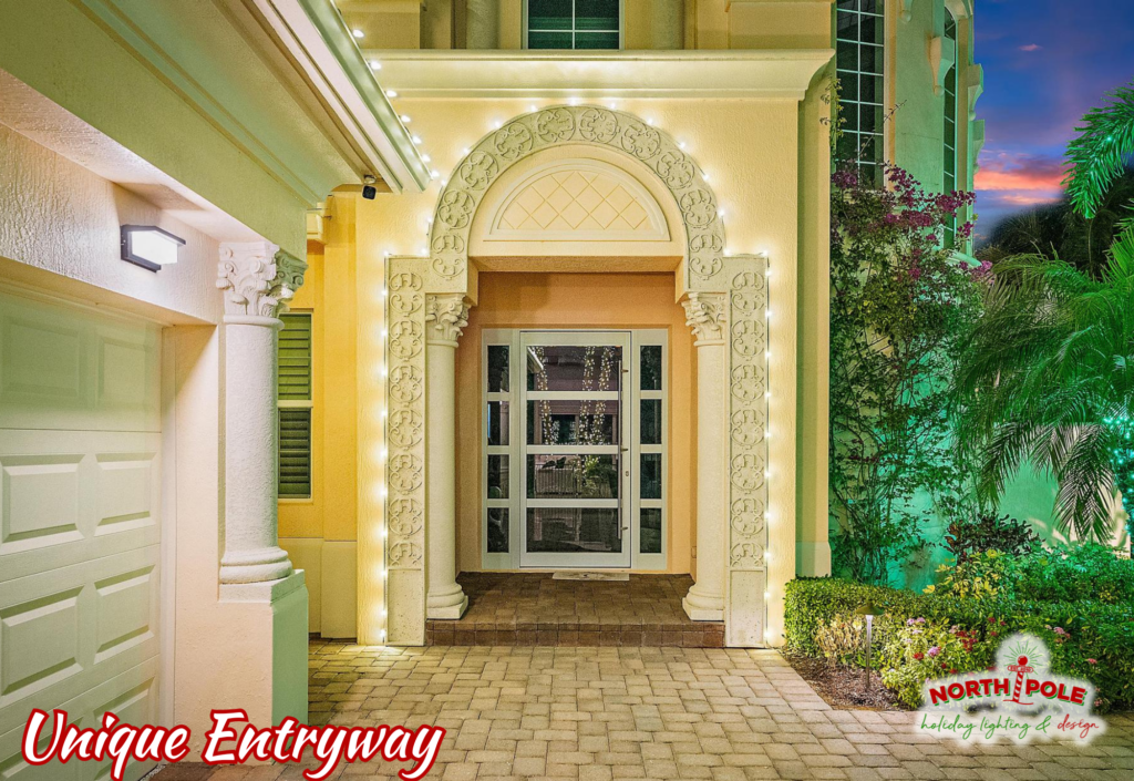 Custom warm white LED holiday lighting following the architectural lines of a stone arched entryway in Stuart, Florida.