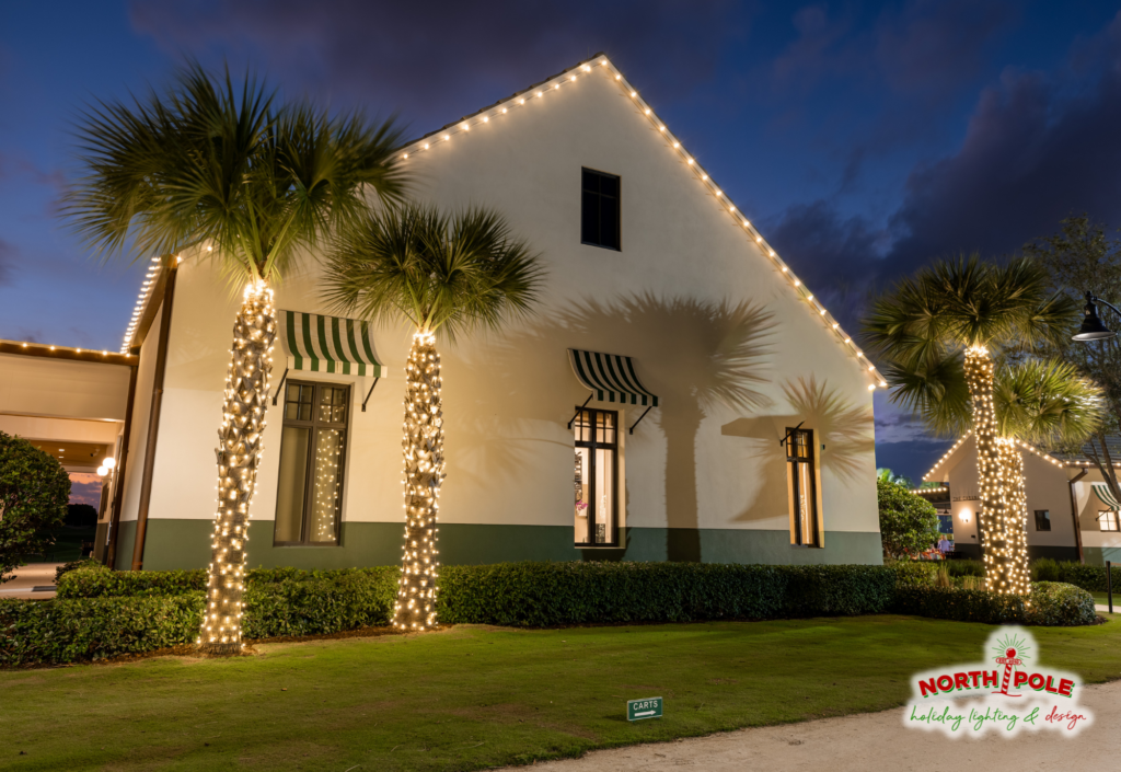 Commercial holiday lighting at The Park West Palm featuring warm white LED tree wraps and festive roofline lights.