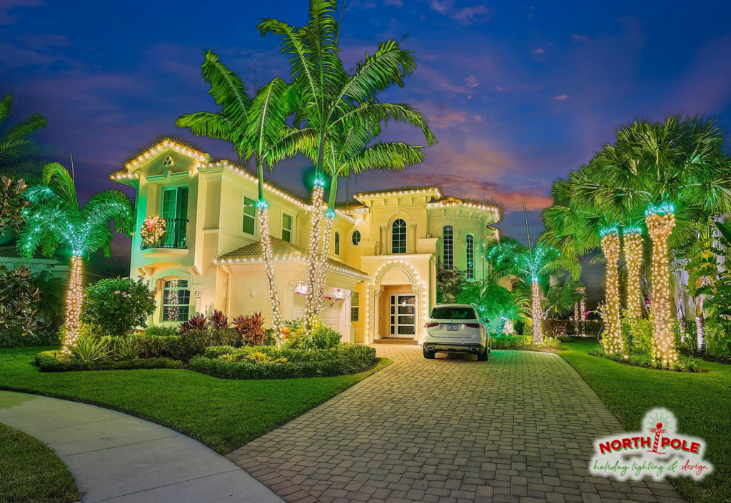 Luxury Hobe Sound estate holiday lighting featuring high-density stacked warm white LED palm wraps with vibrant green crown accents.