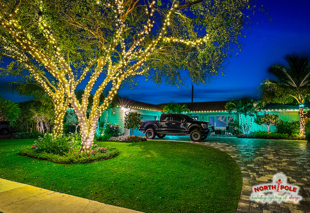 Professional oak tree holiday light wrap in Jupiter, FL, featuring high-density warm white LED stacked trunk and branch wraps.