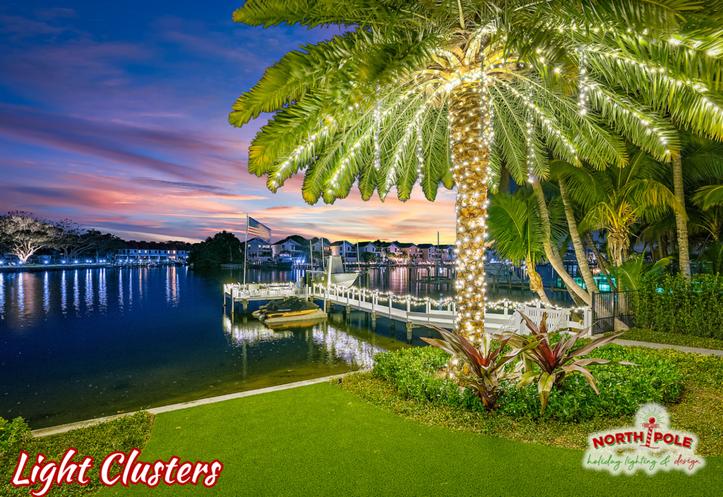 Waterfront Date Palm in Ocean Ridge decorated with warm white LED trunk wraps and dripping light clusters in the fronds.