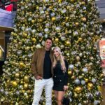 Flocked designer Christmas tree with gold ribbon in a Palm Beach luxury home living room
