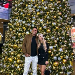 Flocked designer Christmas tree with gold ribbon in a Palm Beach luxury home living room